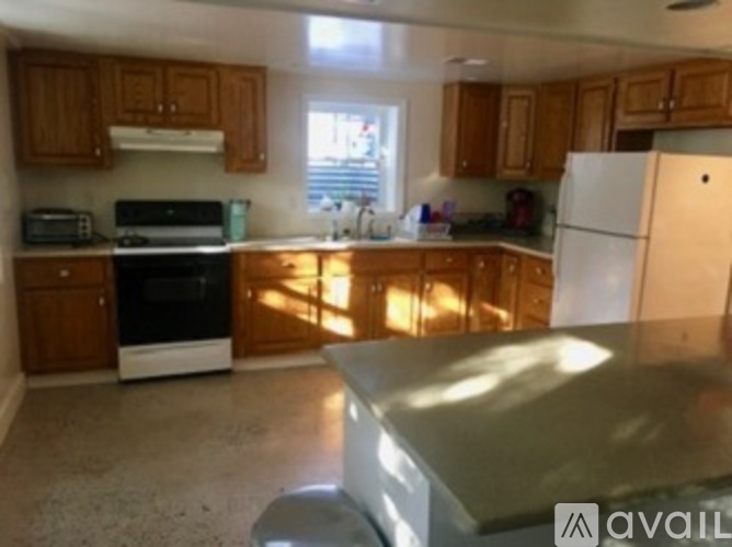 A kitchen with wooden cabinets and a white refrigerator.