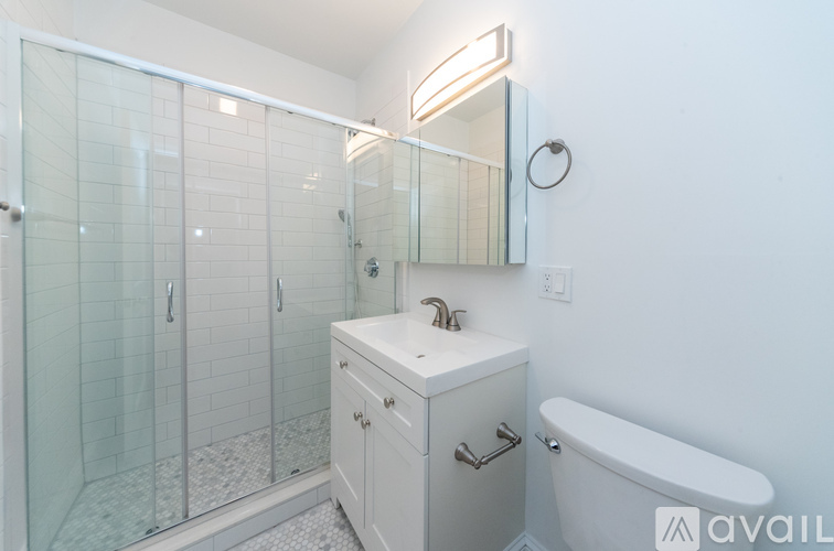 A white bathroom with a glass shower stall and a white tub.