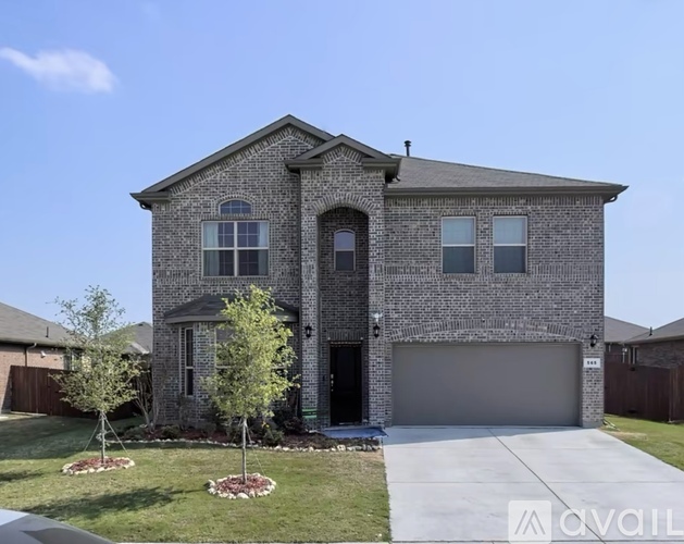 A house with a garage and a driveway in front.