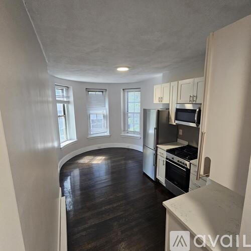 A kitchen with white cabinets and stainless steel appliances.