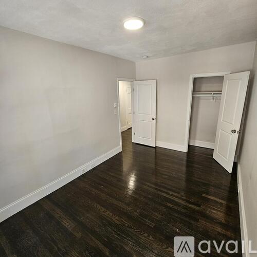 A room with wooden floors and white walls.