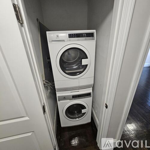 A white washing machine is in a small space.