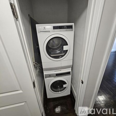 A white washing machine is in a small space.