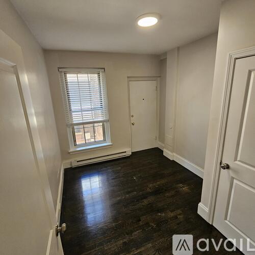 A room with wooden floors and white walls.