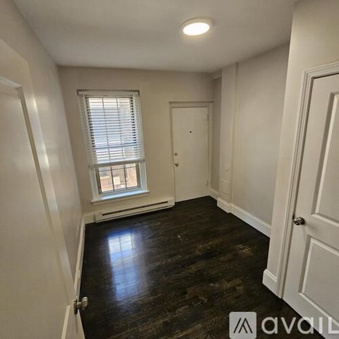 A room with wooden floors and white walls.
