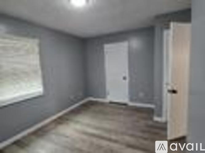 A room with grey walls and a wooden floor.