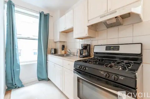 A modern kitchen with a black stove top oven.