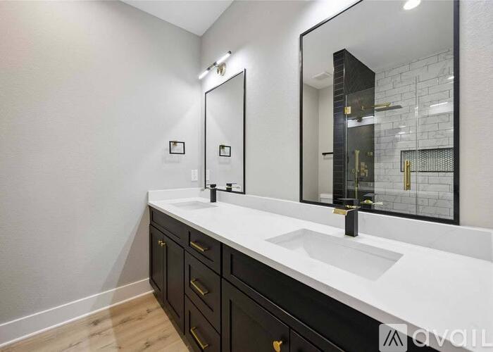 A bathroom with a white countertop and a large mirror.
