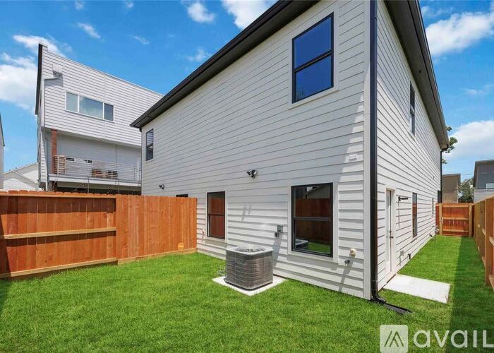 A house with a white exterior and a brown fence.