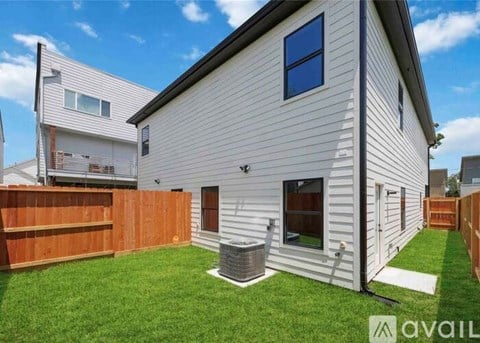 A house with a white exterior and a brown fence.