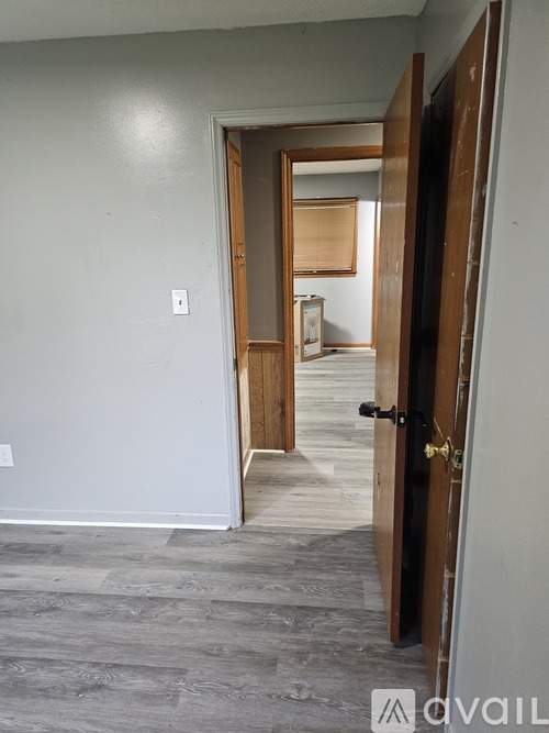 A room with a door and a wall socket.