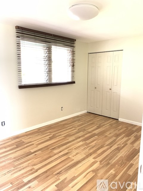 A room with wooden flooring and a white door.