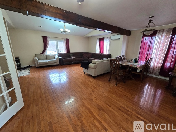 A living room with wooden floors and furniture.