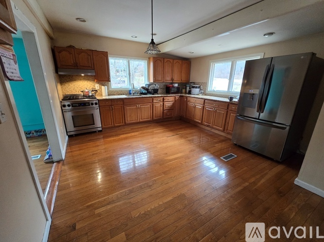 A kitchen with wooden floors and stainless steel appliances.