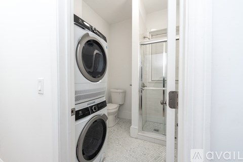 A white washer and dryer in a small laundry room.