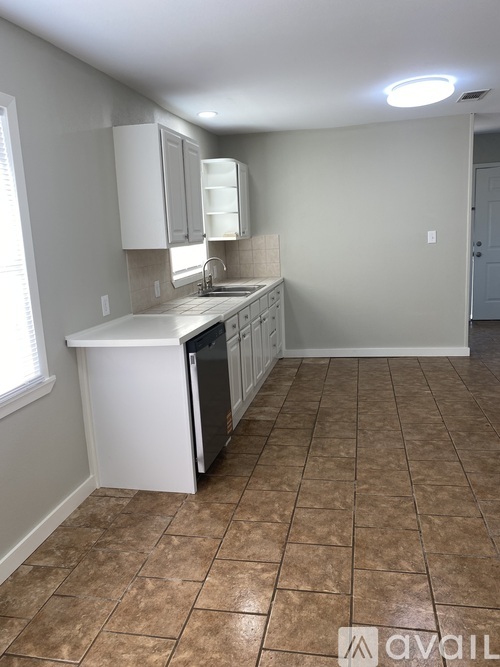 A kitchen with a sink and a window.