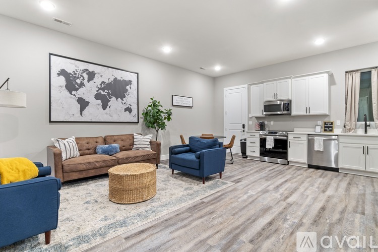 A living room with a world map on the wall and a kitchen area in the background.