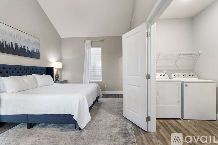 A bedroom with a large bed and a white wardrobe.