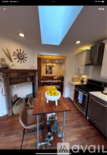 A kitchen with a wooden table and a bowl of lemons on it.