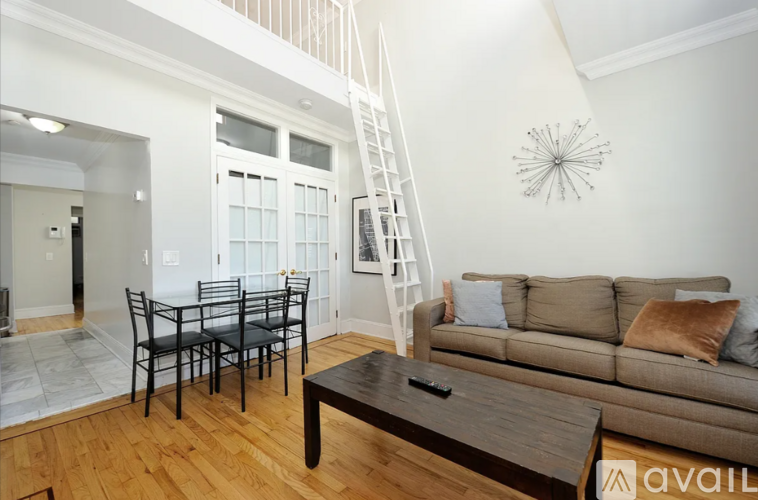 A living room with a brown couch and a coffee table.