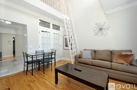A living room with a brown couch and a coffee table.