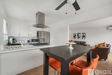 A modern kitchen with a dining table and chairs.
