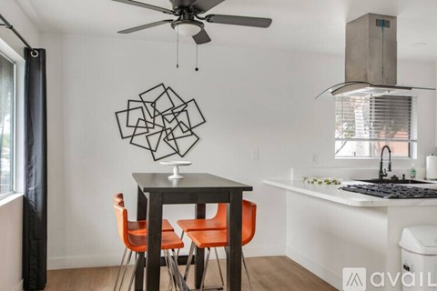 A modern kitchen with a table and chairs.