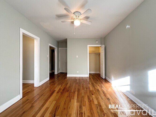 A room with wooden floors and a ceiling fan.