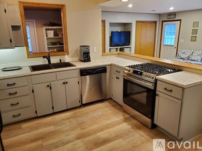 A kitchen with a stove top oven and a dishwasher.