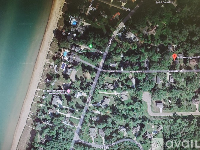 A satellite image of a coastal area with roads and buildings.