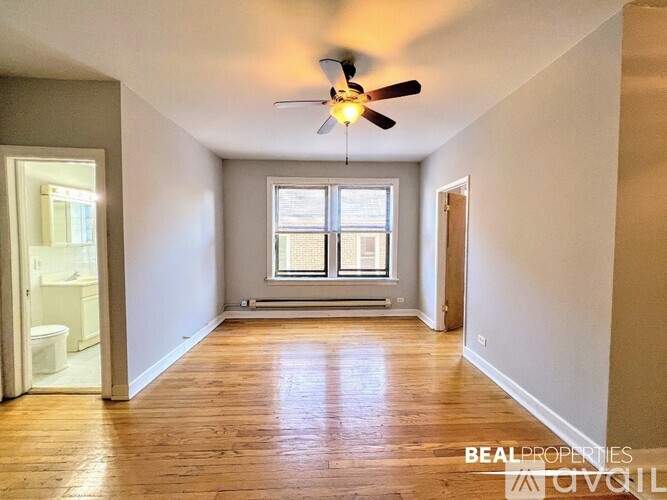 A spacious room with a ceiling fan and a window.