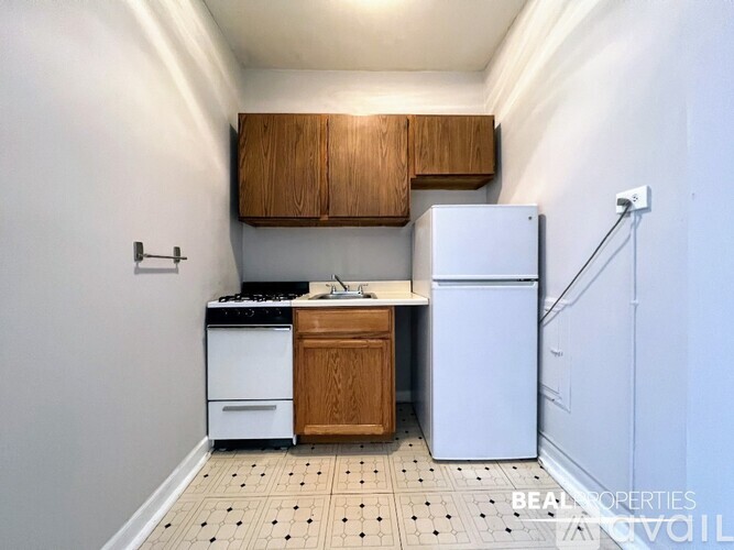 A kitchen with a white fridge, white oven, and white dishwasher.
