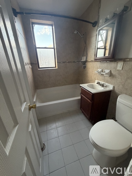A bathroom with a toilet, sink, and tub.