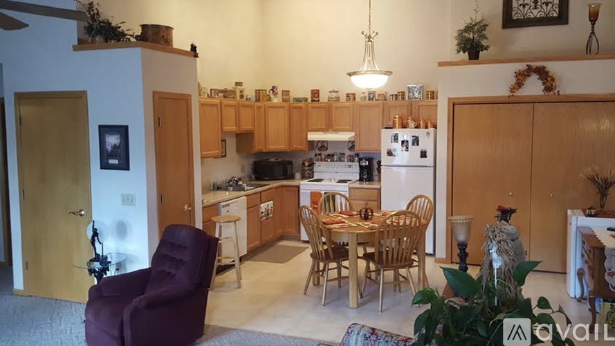A kitchen with a table and chairs in the middle of the room.