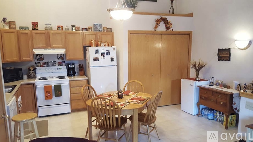 A kitchen with a table set for a meal.