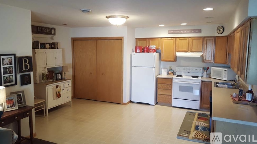 A kitchen with wooden cabinets and white appliances.