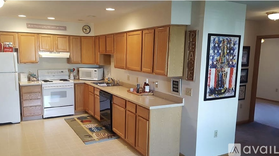 A kitchen with wooden cabinets and a white refrigerator.