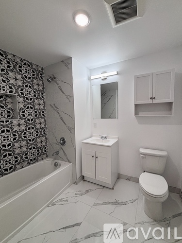 A bathroom with a toilet, sink, and bathtub.