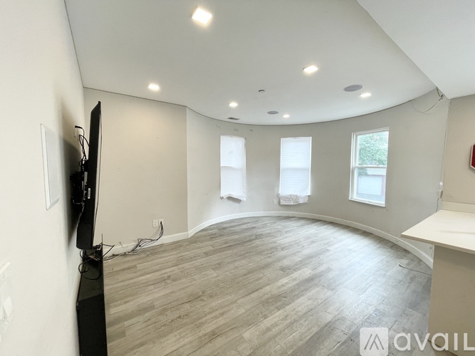 A living room with a television and a fireplace.