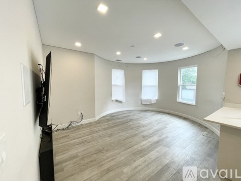 A living room with a television and a fireplace.
