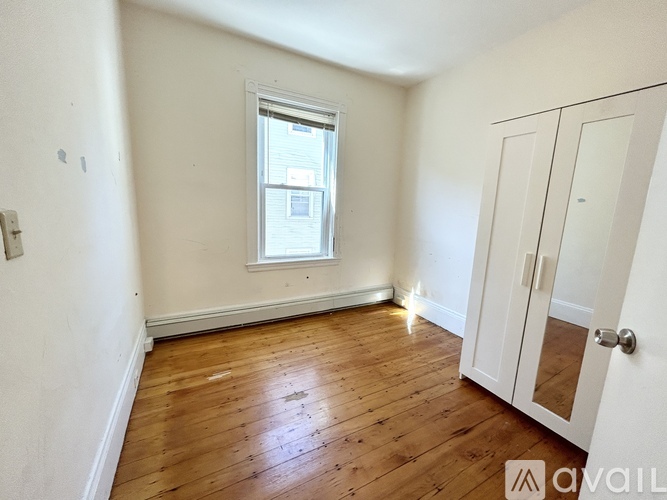 A room with wooden floors and a white door.