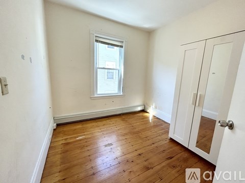 A room with wooden floors and a white door.