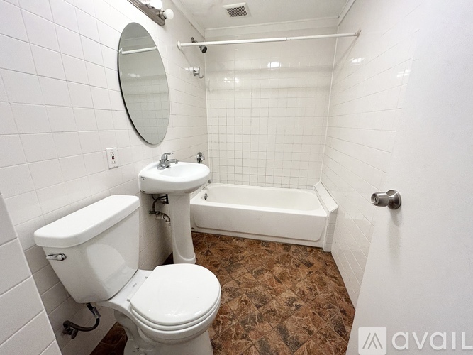 A white toilet and sink in a small bathroom.