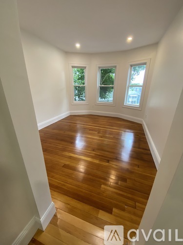 A room with wooden floors and white walls.