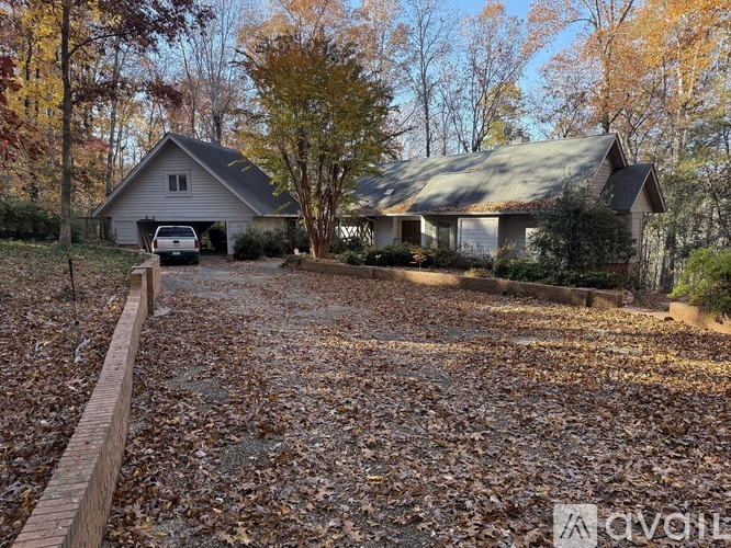 A house with a grey roof and a car in the driveway.