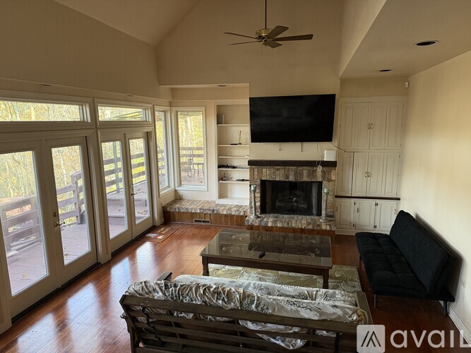 A living room with a fireplace and a television.