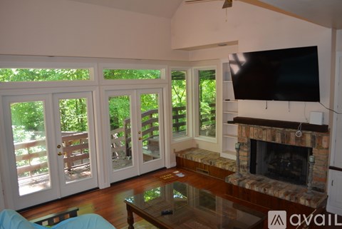 A living room with a fireplace and a television.