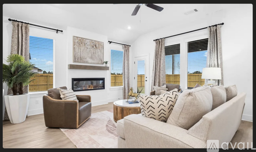 A living room with a fireplace, a couch, and a chair.