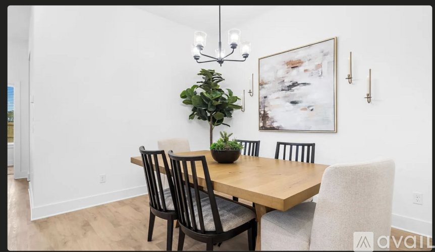 A dining room with a wooden table and chairs.