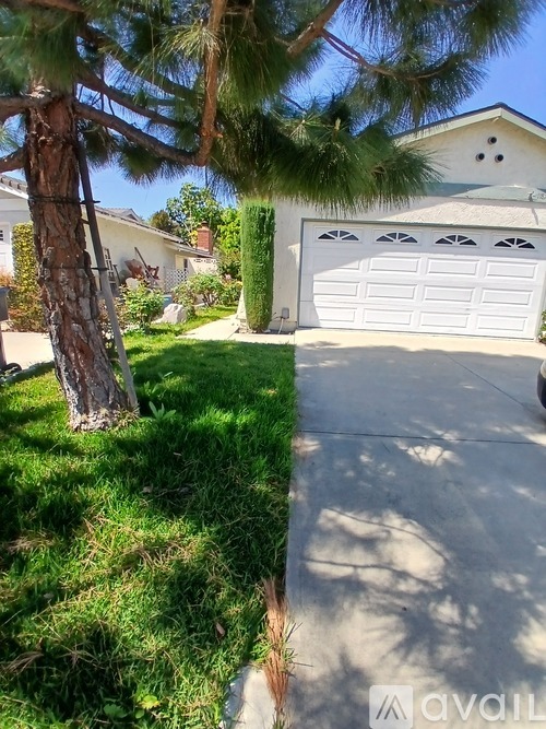 A house with a white garage door is shown in the image.